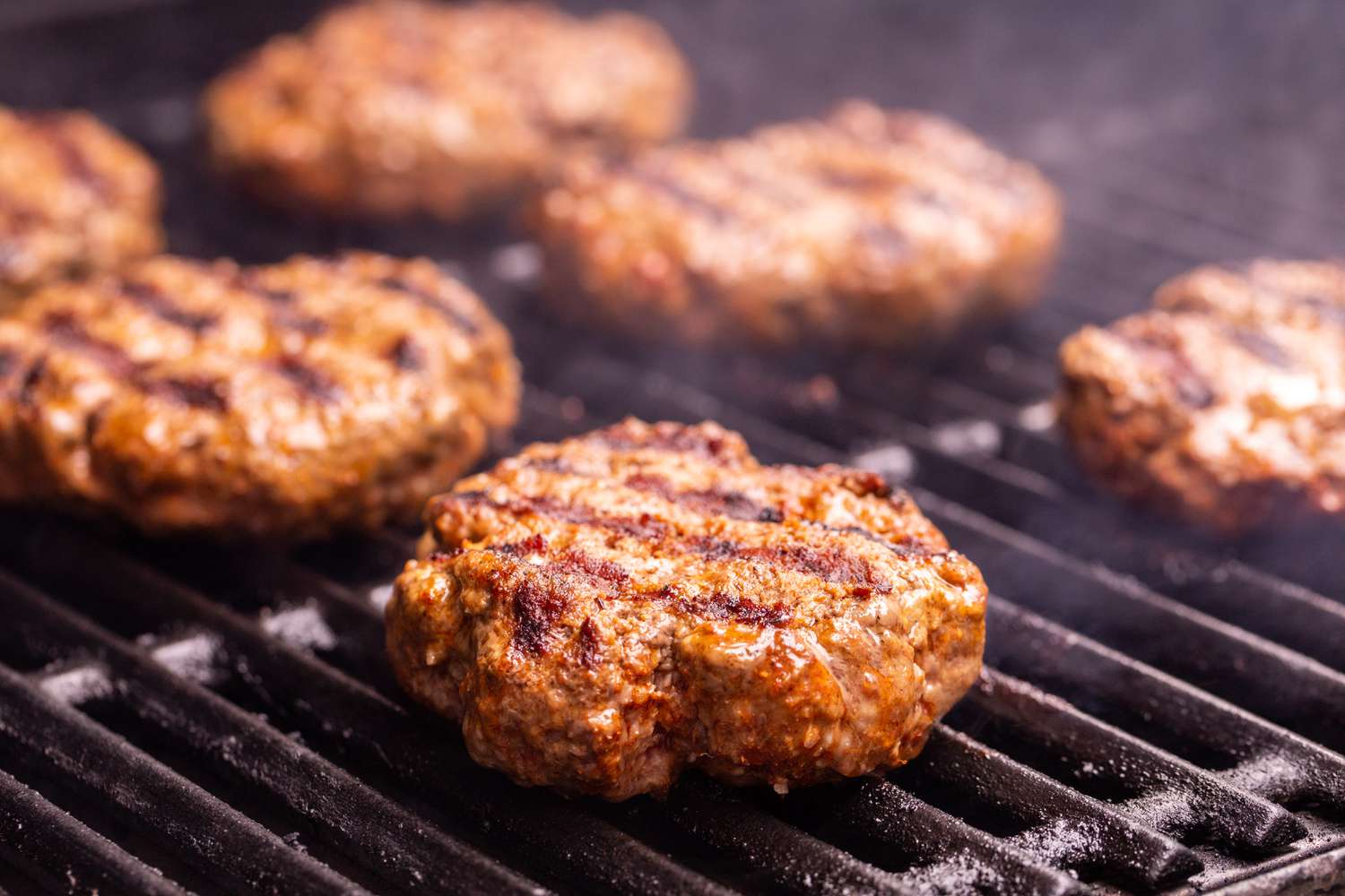 Burger patties on the grill for Nacho Mexican Burger.
