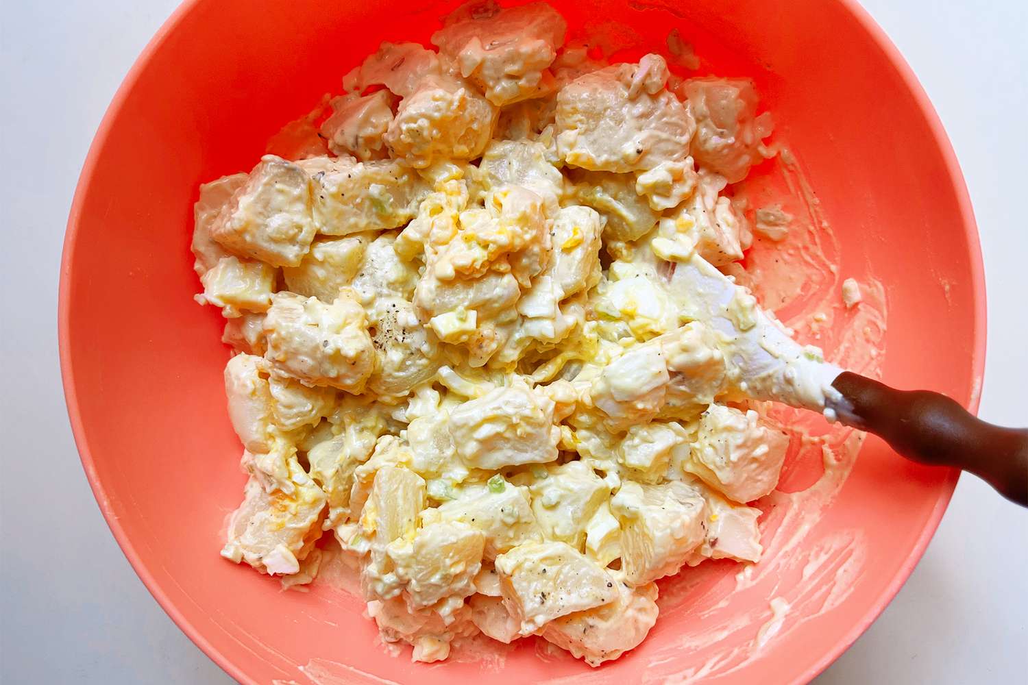 Bowl of potato salad with serving spatula