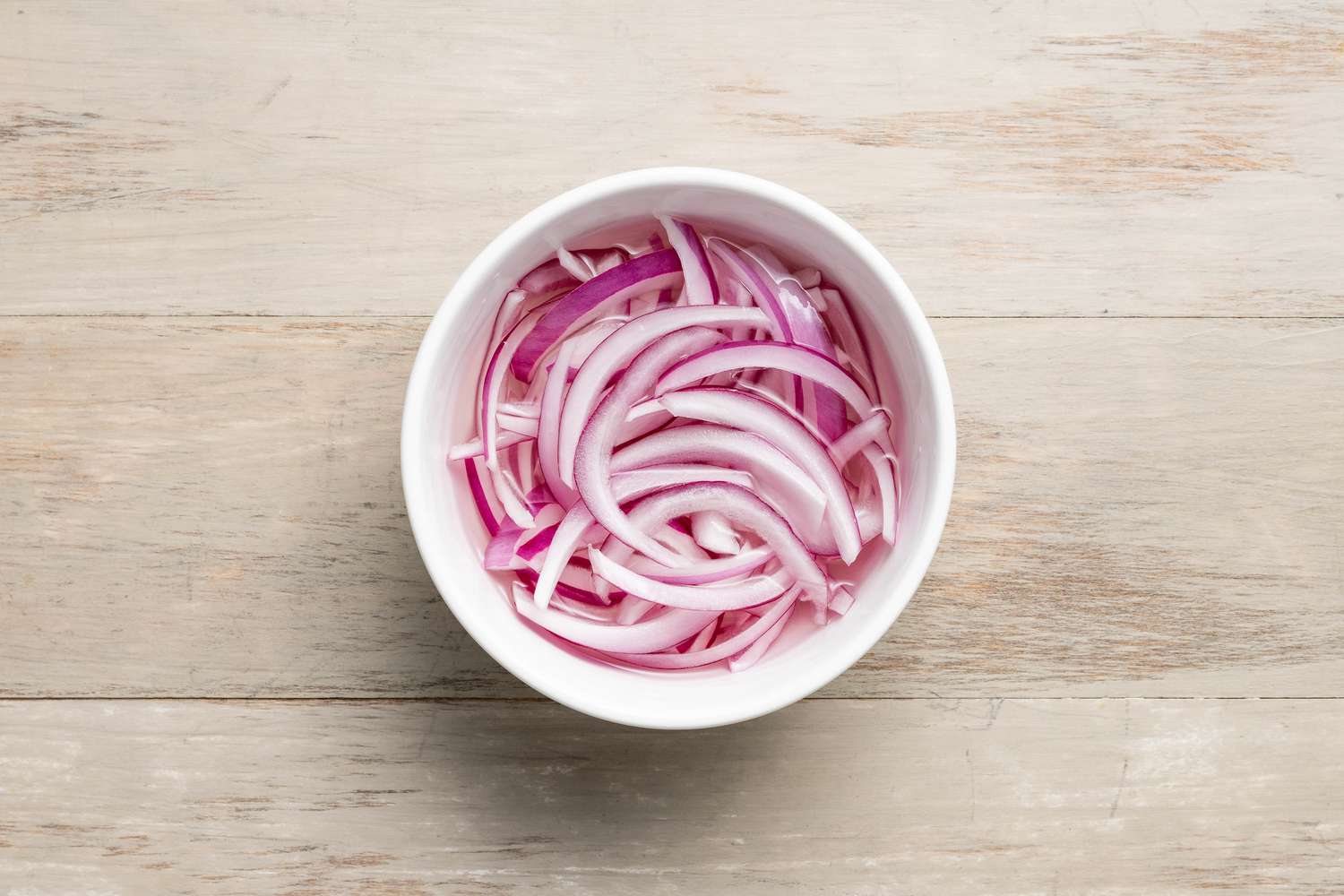 Bowl of Sliced Red Onion Pickles for Wedge Salad Sandwich Recipe