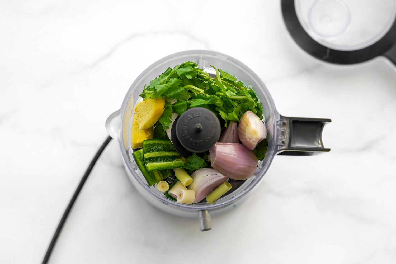 Shallots, Ginger, Lemon Grass, Peppers and Cilantro in a Food Processor for Microwave Red Curry Poached Salmon Recipe