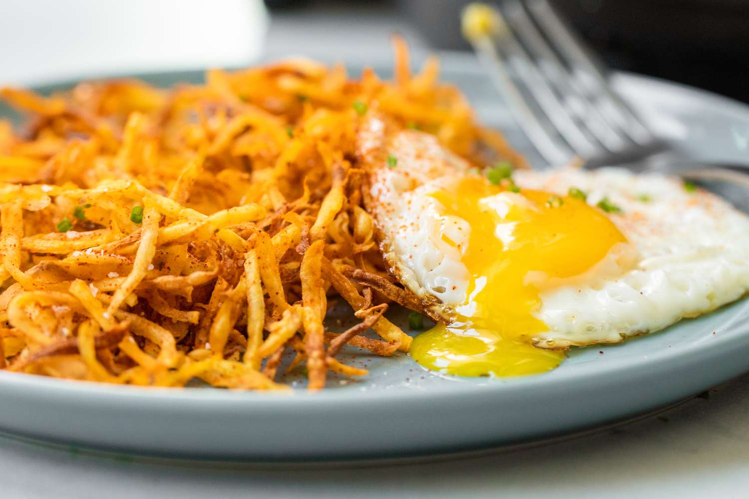 Air Fryer Hash Browns on a Plate with a Sunny Side Egg