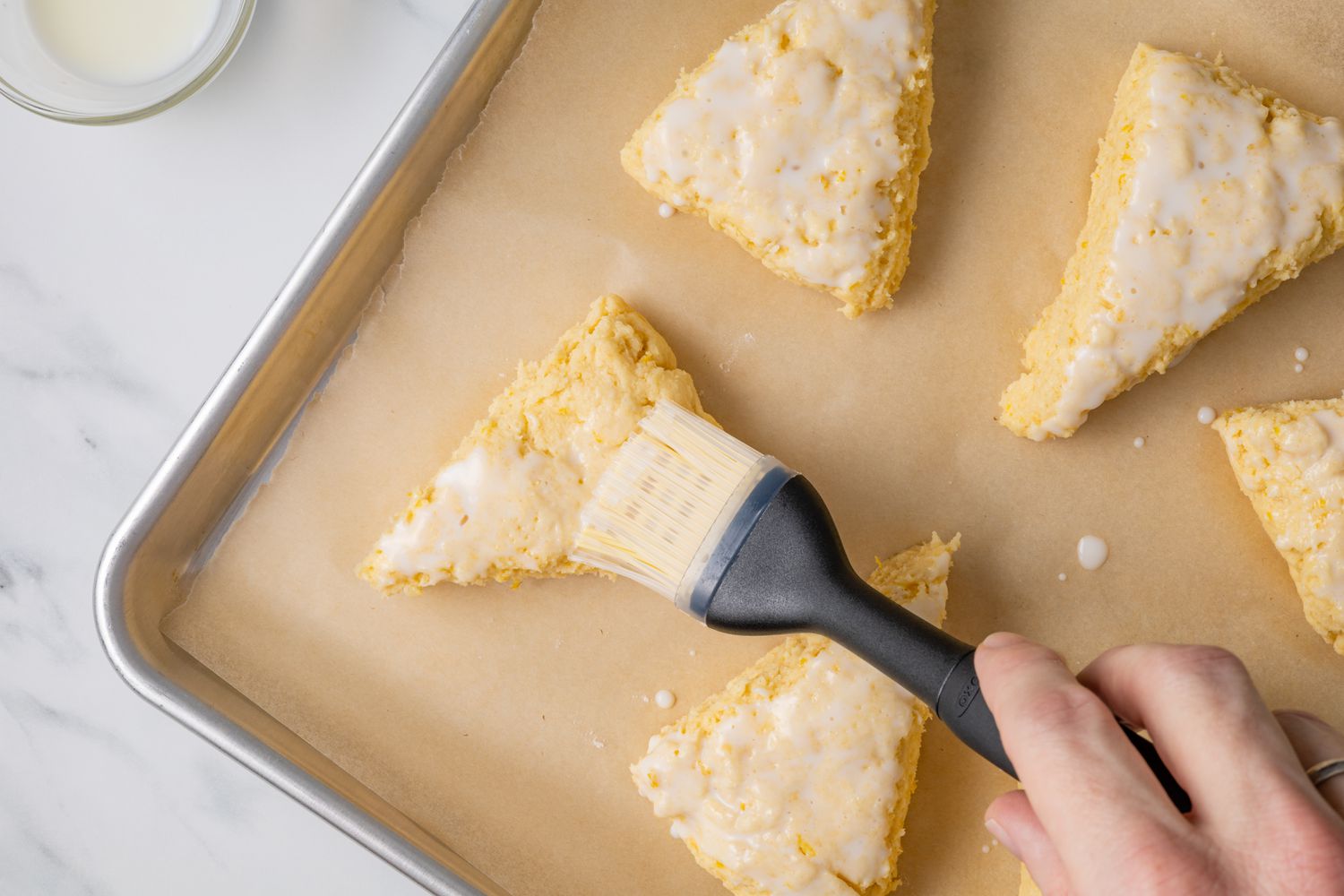 Buttermilk Brushed onto Lemon Scones on Tray with Parchment