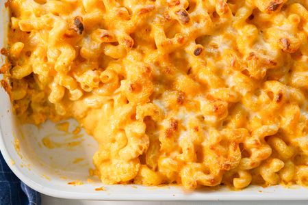 Overhead view of baked macaroni and cheese with a serving removed