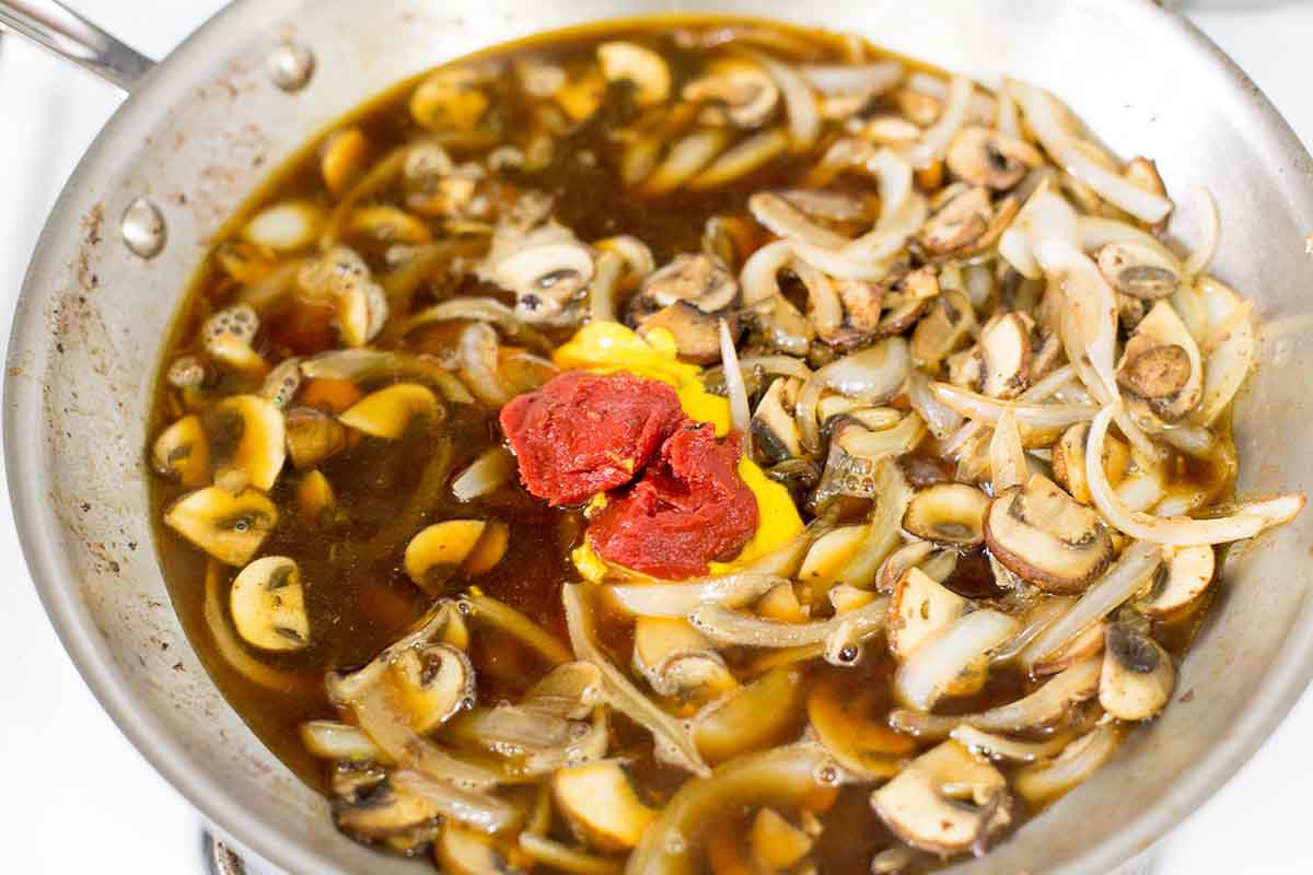 Add mustard and tomato paste to the sauce for salisbury steak gravy