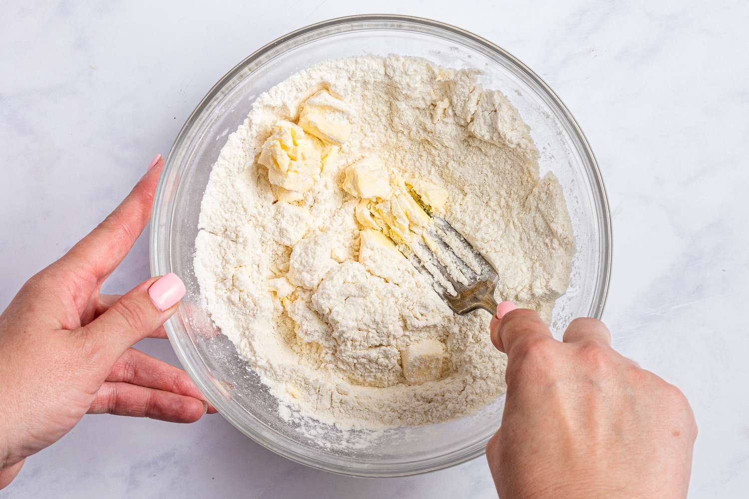 Mixing the topping for a blackberry cobbler recipe.