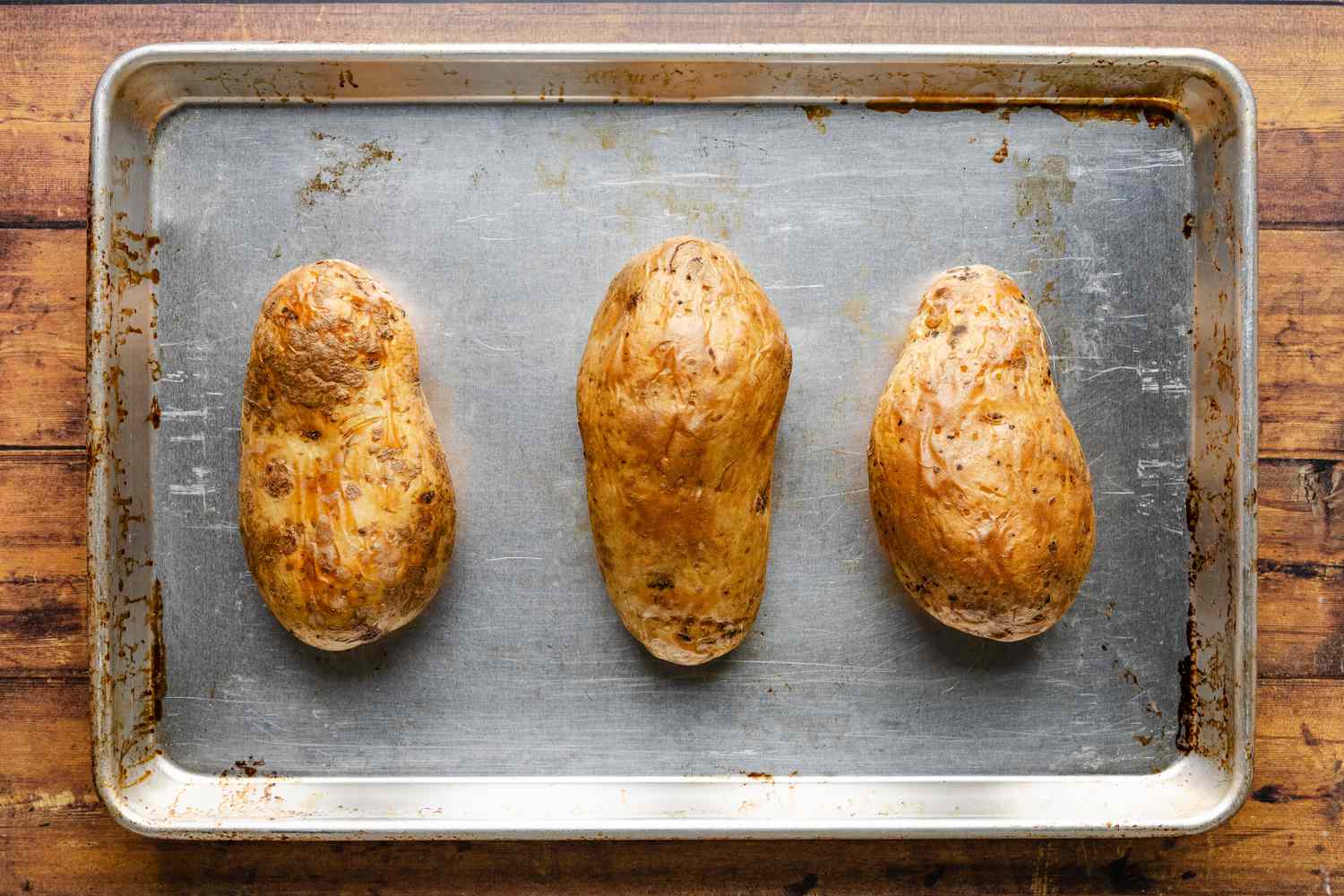 baked potatoes on a baking sheet for cheeseburger stuffed baked potatoes recipe