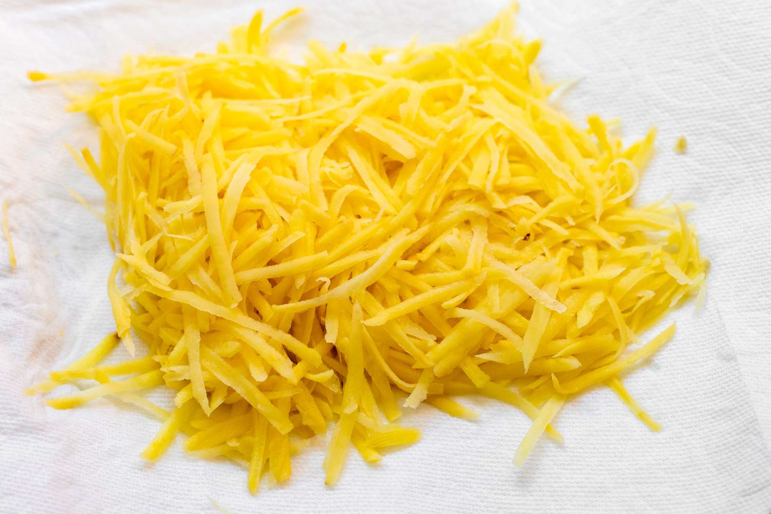 Shredded Potatoes on Paper Towel for Air Fryer Hash Brown Recipe