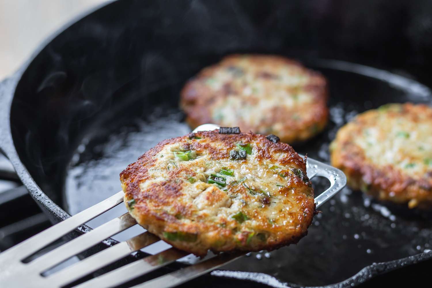 How to make salmon cakes and lifting the pan fried cakes out of the pan.
