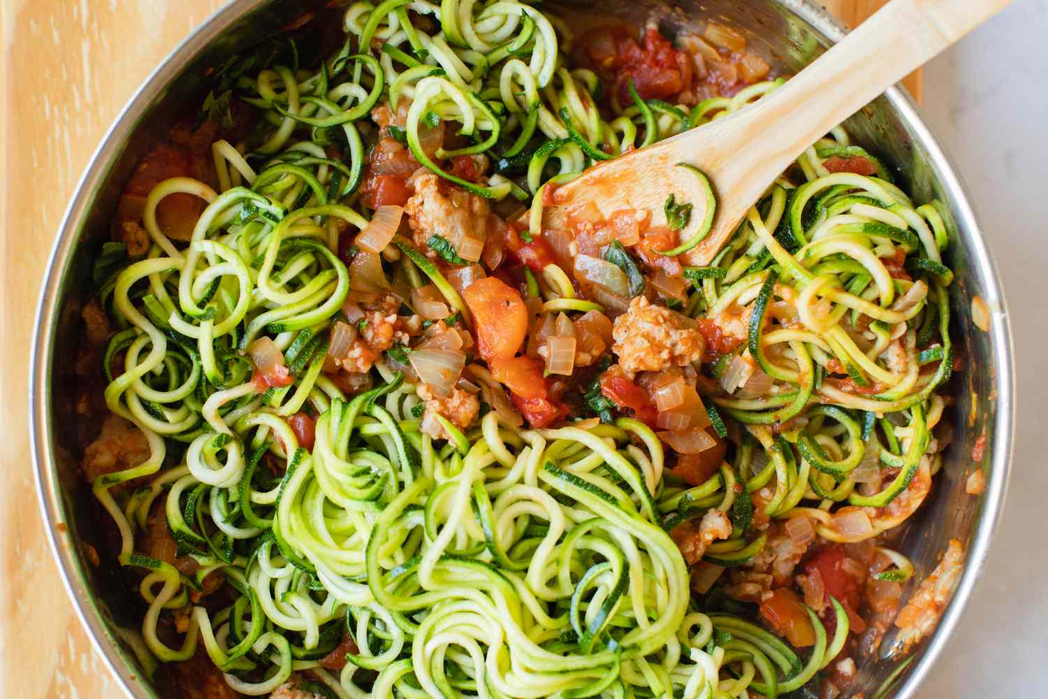 Zucchini Noodle Mixed into Sauce for Casserole Recipe