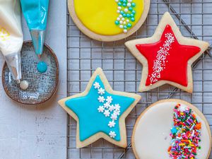 Royal icing for sugar cookies decorated and set on a cooling rack.