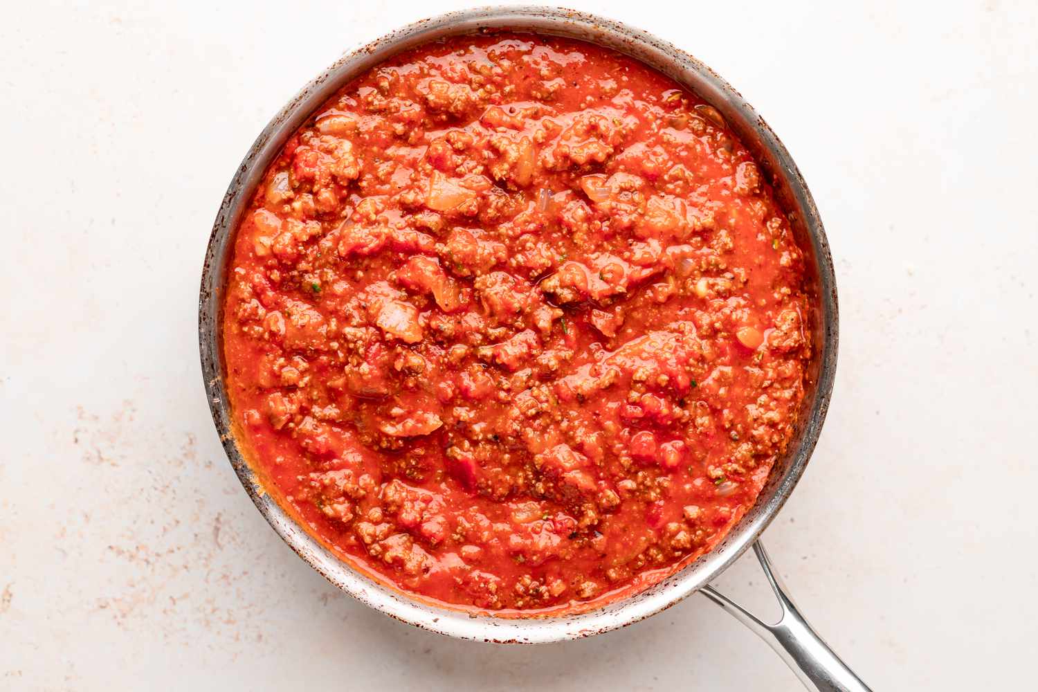 Meat sauce in a skillet for a baked ziti recipe.