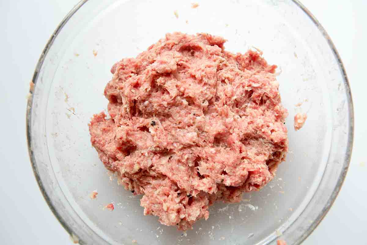 A Swedish meatball mixture in a glass bowl