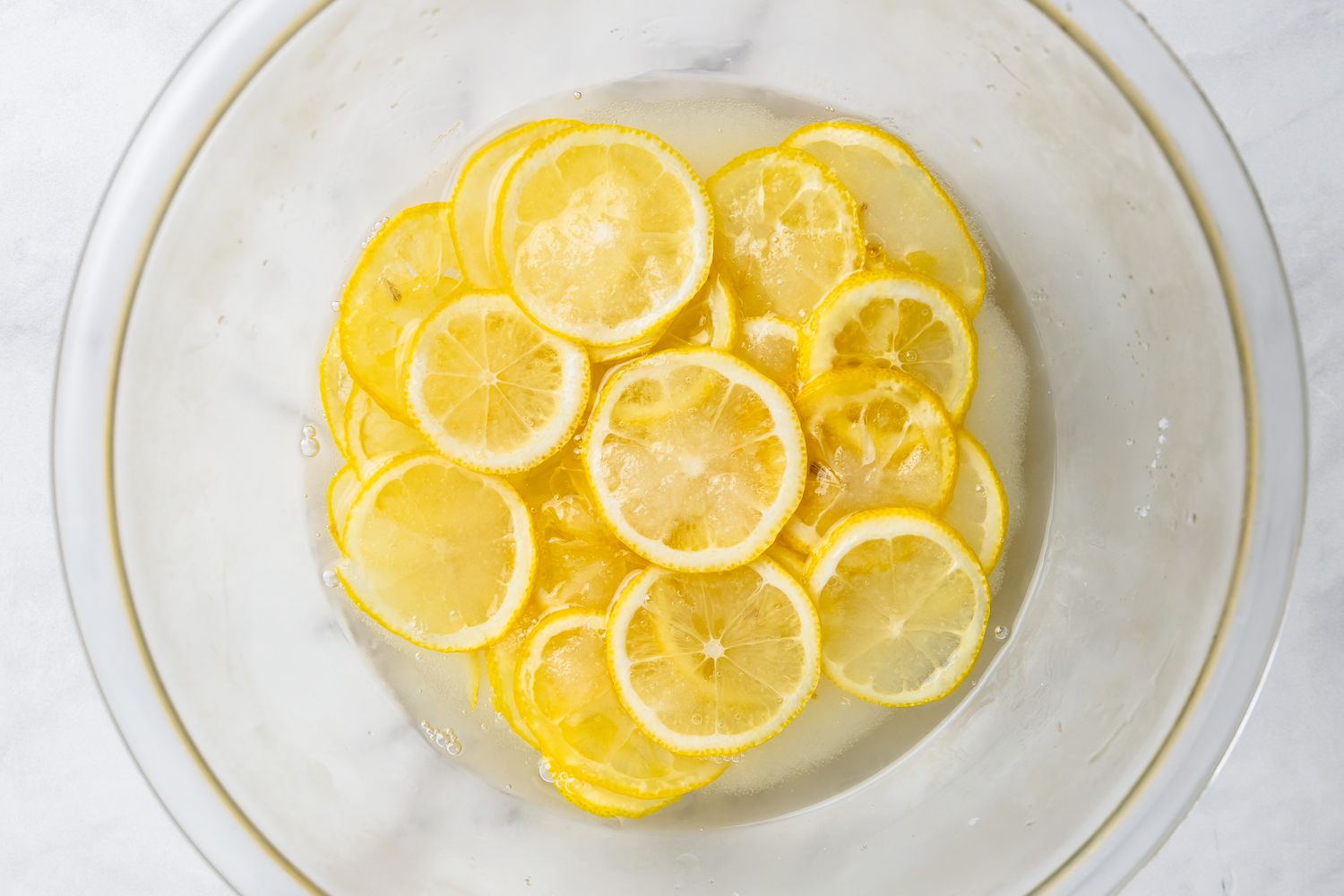 Bowl of Lemon Slices Sitting in Sugar and Lemon Juice for Lemon Bars