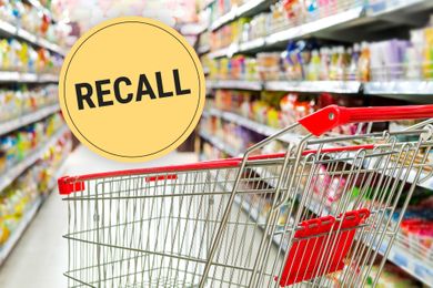 Shopping cart in a supermarket aisle with a RECALL sign superimposed