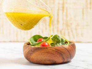 3-minute lemon dressing poured onto a small bowl of salad