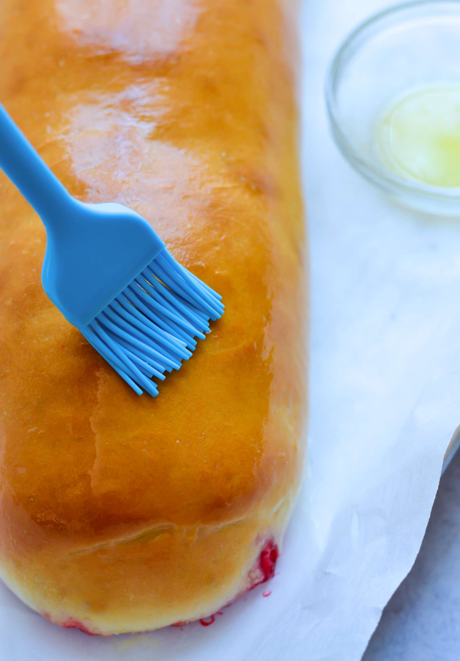 Brushing finished salra dough with melted butter