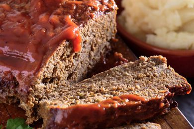 Closeup of a meatloaf with one slice cut off