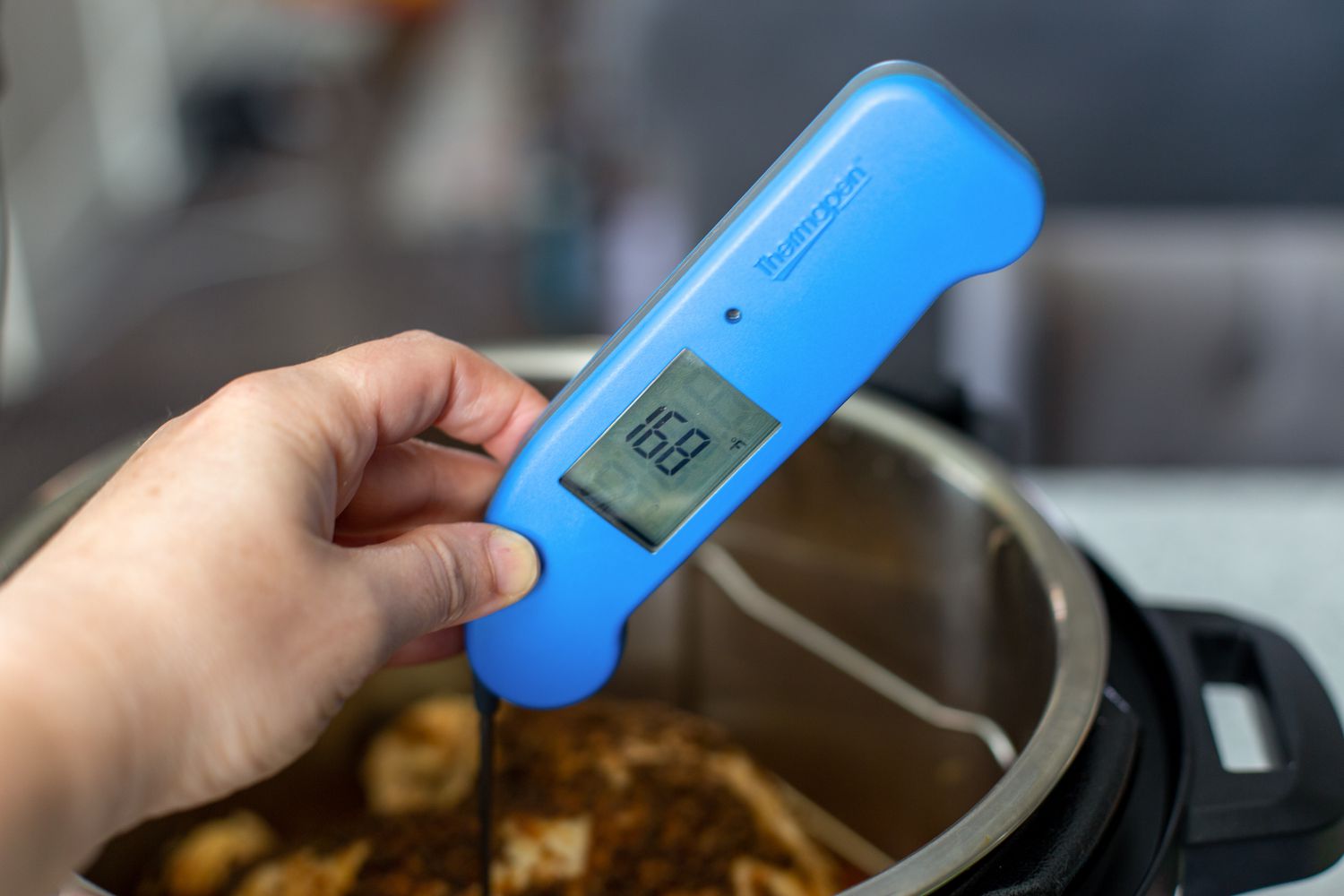 Using a thermapen to check the internal temperature of a simple instant pot turkey with gravy.