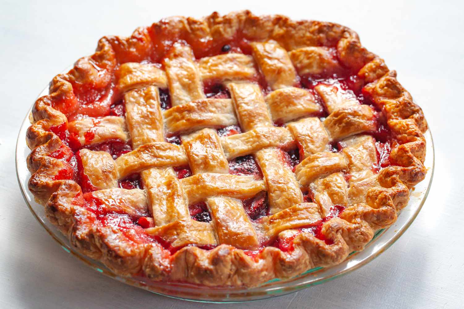 A whole pie with a lattice pie crust.