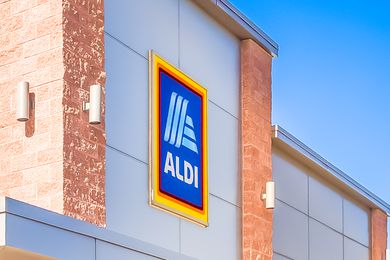 The sign for an Aldi store on the side of a building
