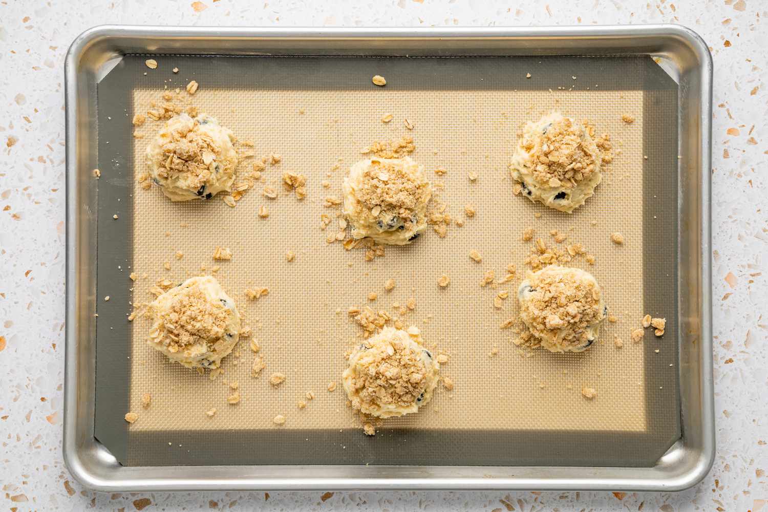 Streusel Layer Added to Portioned Blueberry Muffin Tops