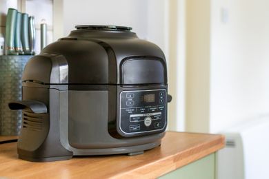Kitchen countertop with an air fryer in the foreground