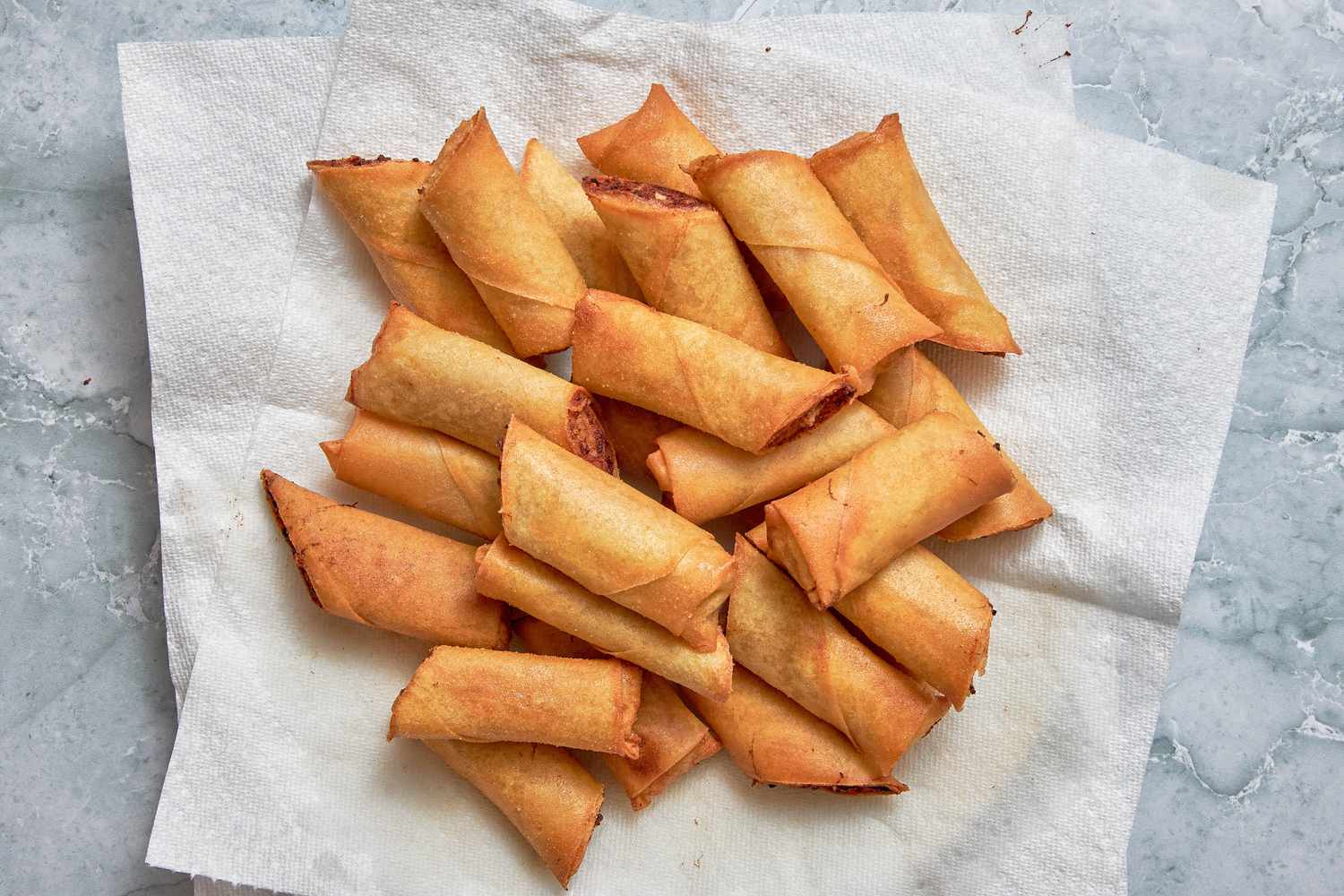 Freshly Fried Lumpia Resting on a Paper Towel Lined Plate