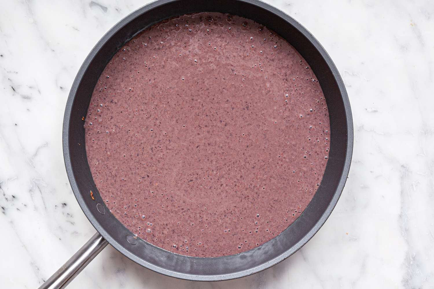 Sauce for Black Bean Enfrijoladas in a skillet.