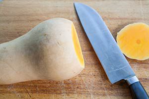 Butternut squash with bottom sliced off by kitchen knife