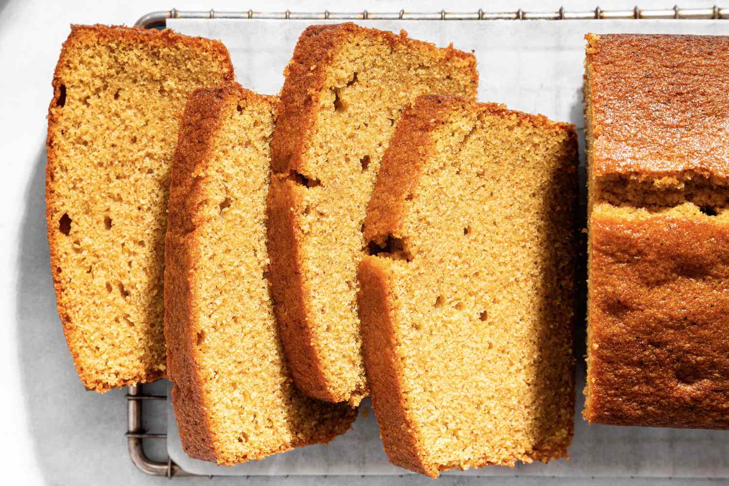 Sliced brown sugar pound cake on a cooling rack displaying its texture and layers