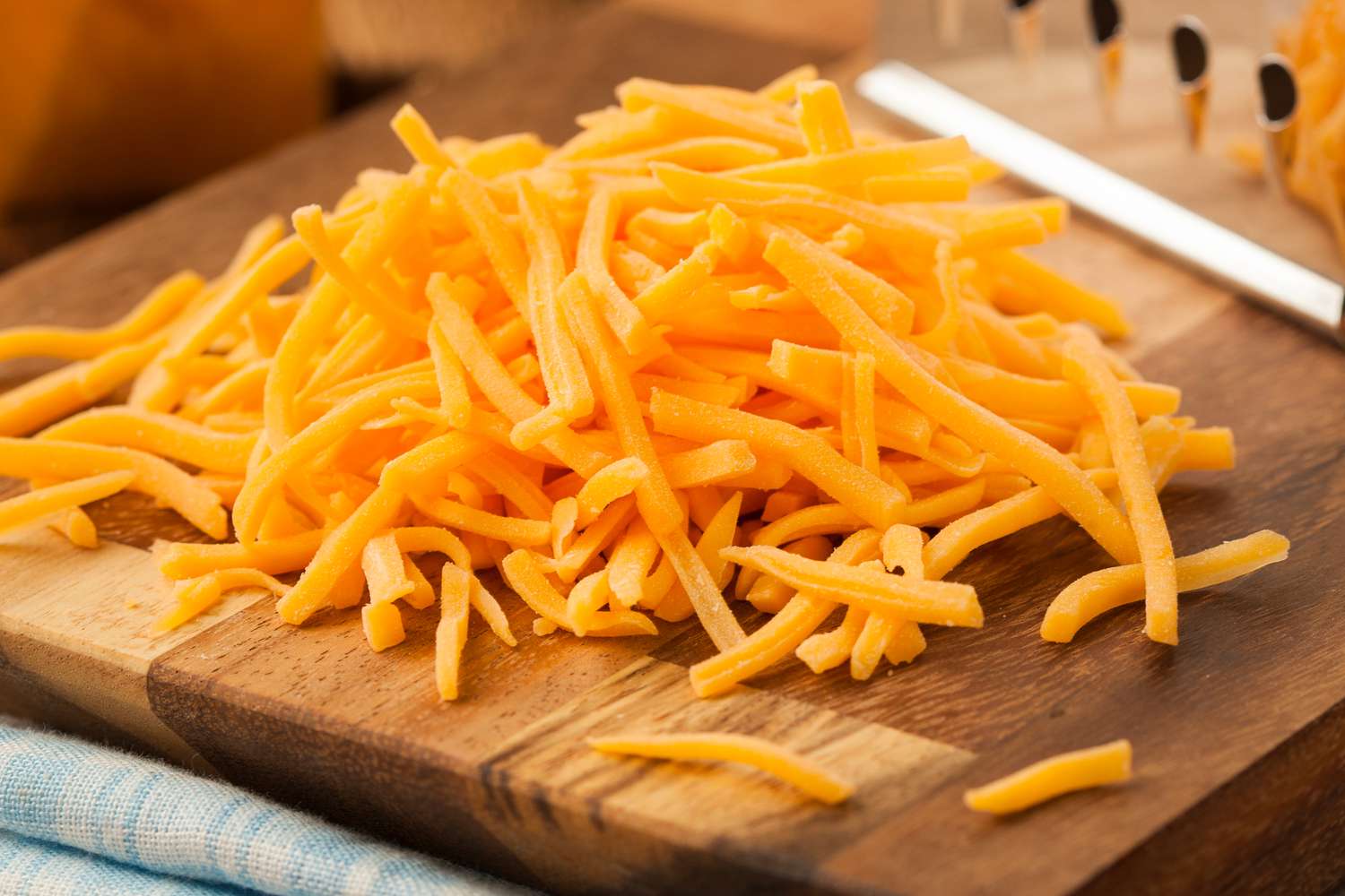 Organic Shredded Sharp Cheddar Cheese on a Cutting Board