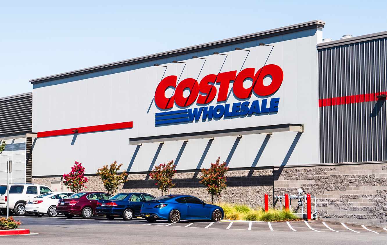 The exterior of a Costco Wholesale store with cars parked in front of it