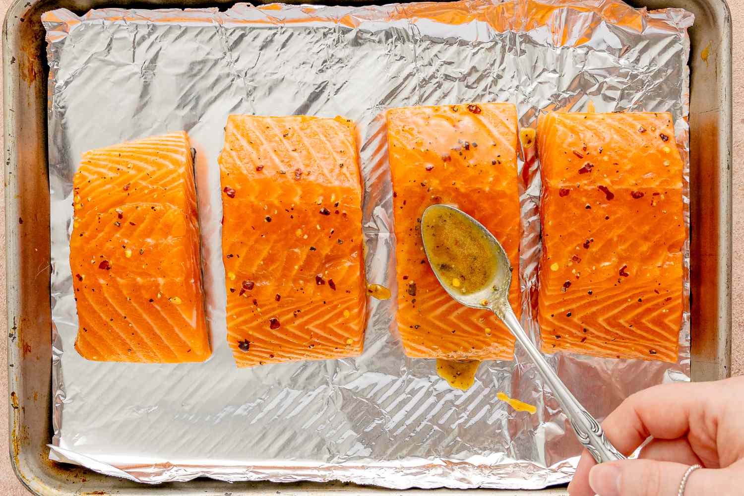 Salmon filets on a foil-lined baking sheet