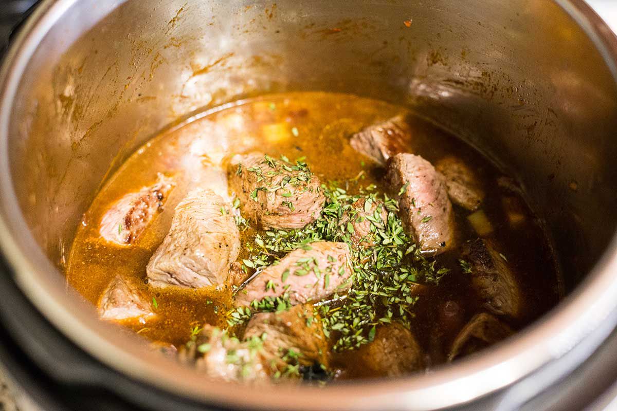 Combine the meat and liquids in the Instant Pot for cooking