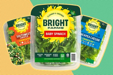 Three boxes of BrightFarms salad kits and spinach. 