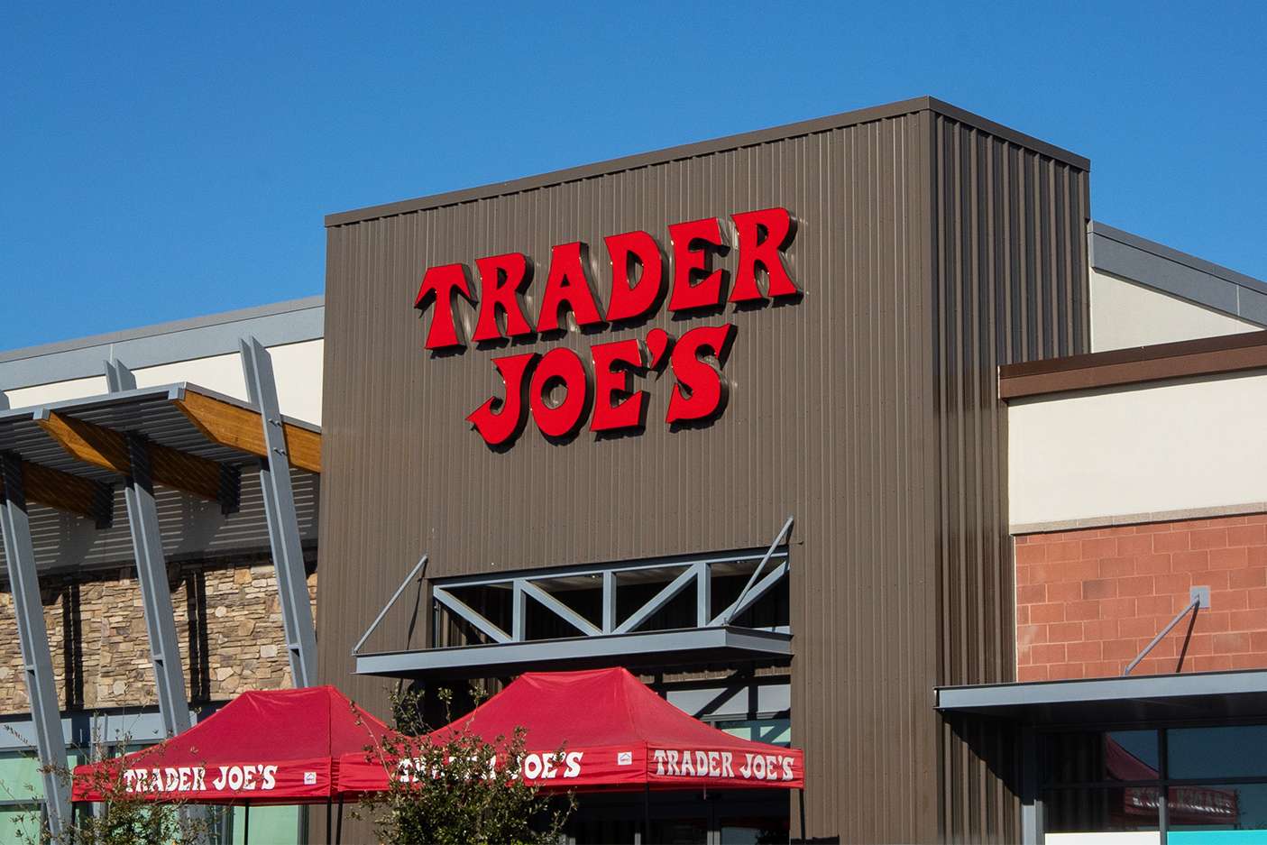 Trader Joes storefront with branded signage and red outdoor covers