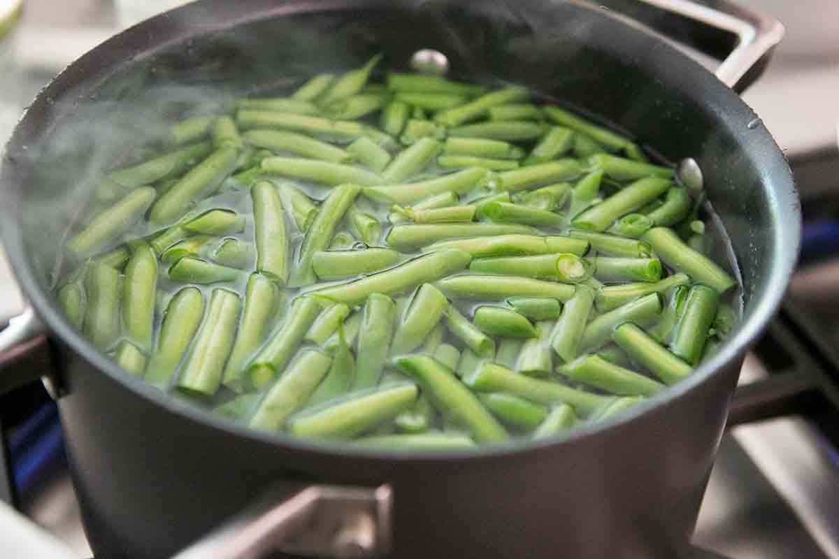 green beans cooking in a pot of water