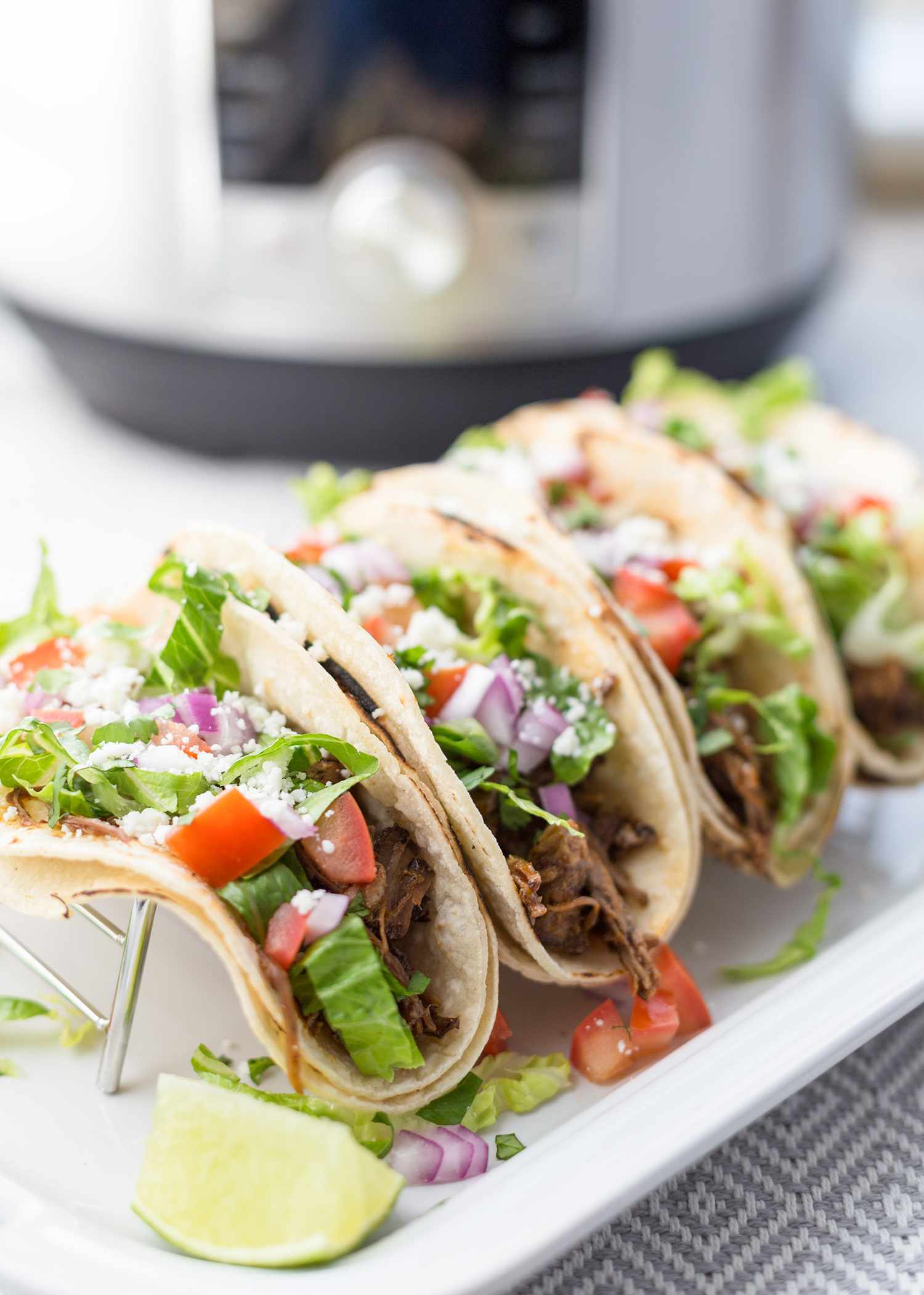 Instant Pot Pulled Pork served in tacos on a platter