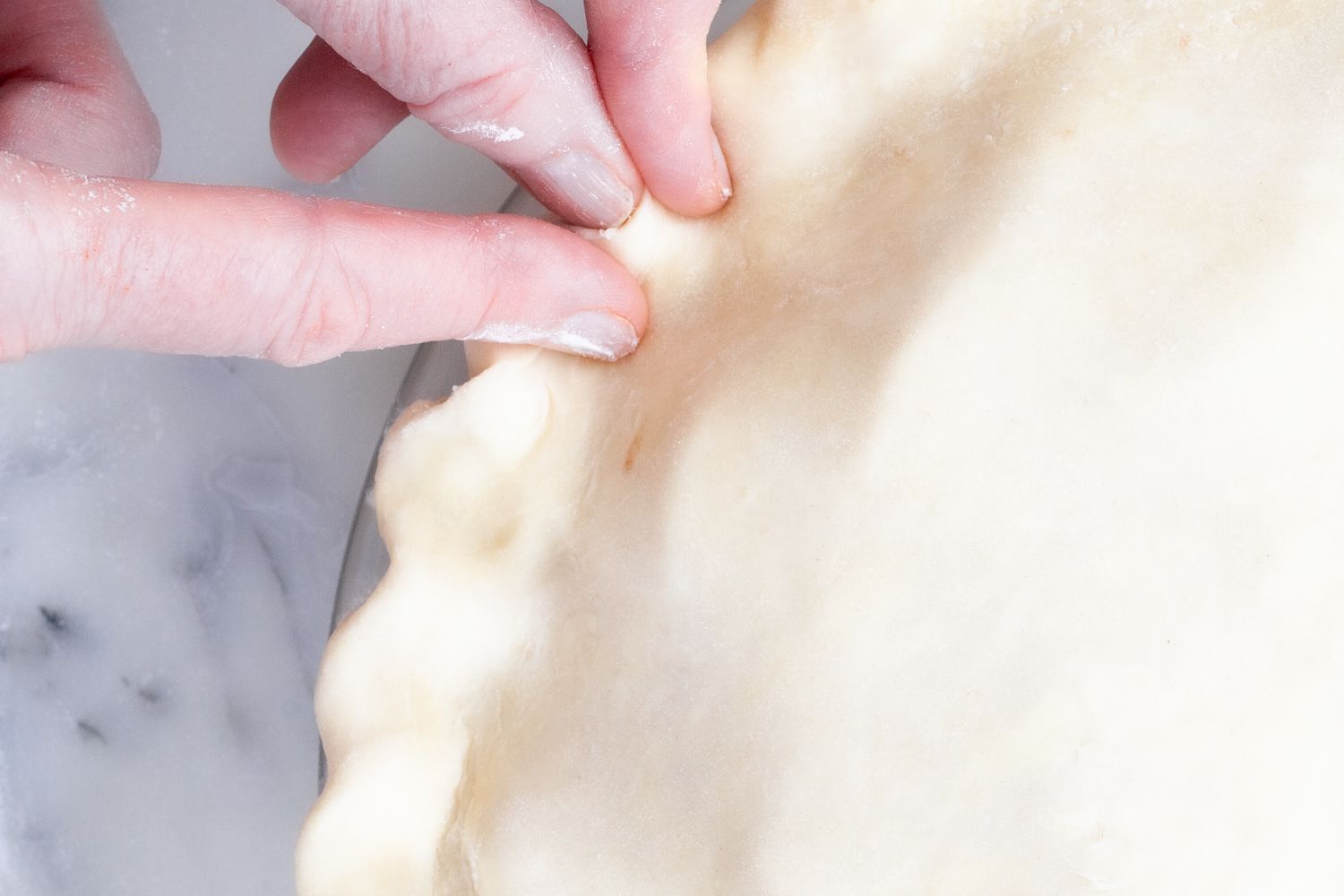 Crimping the edge of a pie crust.