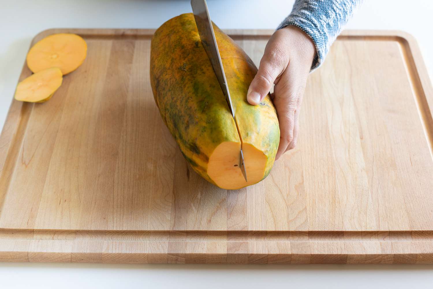 Cutting a papaya in half lengthwise
