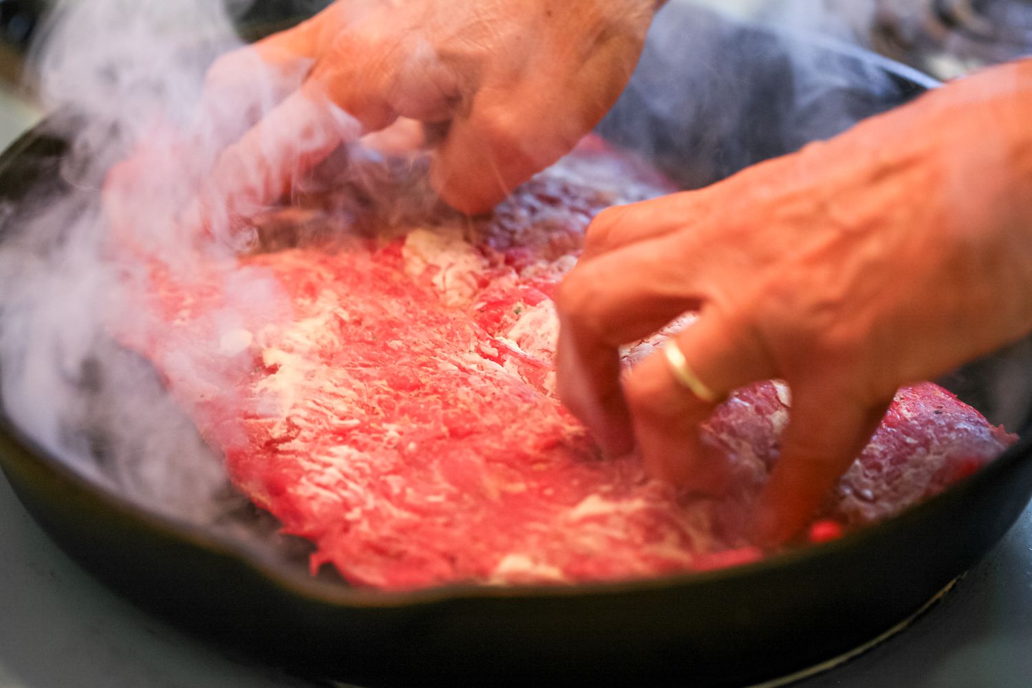 Cooking flank steak in a cast iron skillet.