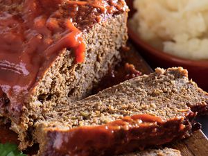 Closeup of a meatloaf with one slice cut off