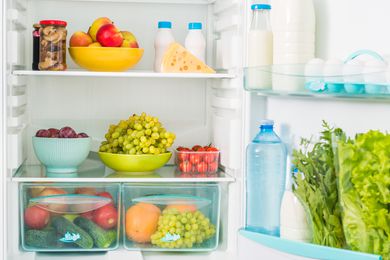 Inside of a fridge filled with different foods and drinks