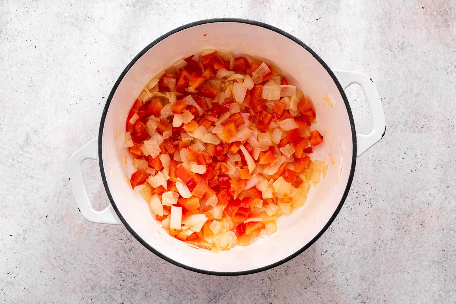 Diced Bell Peppers and Onions Cooking in a Dutch Oven for One-Pot Taco Pasta Recipe