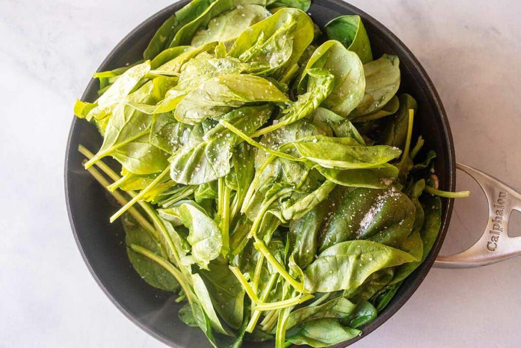 Spinach in a bowl for spinach feta dip in the crockpot
