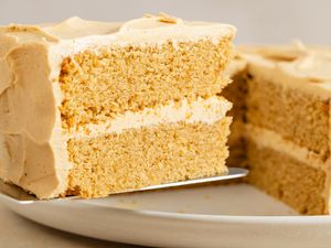 A slice of peanut butter cake with frosting on a plate