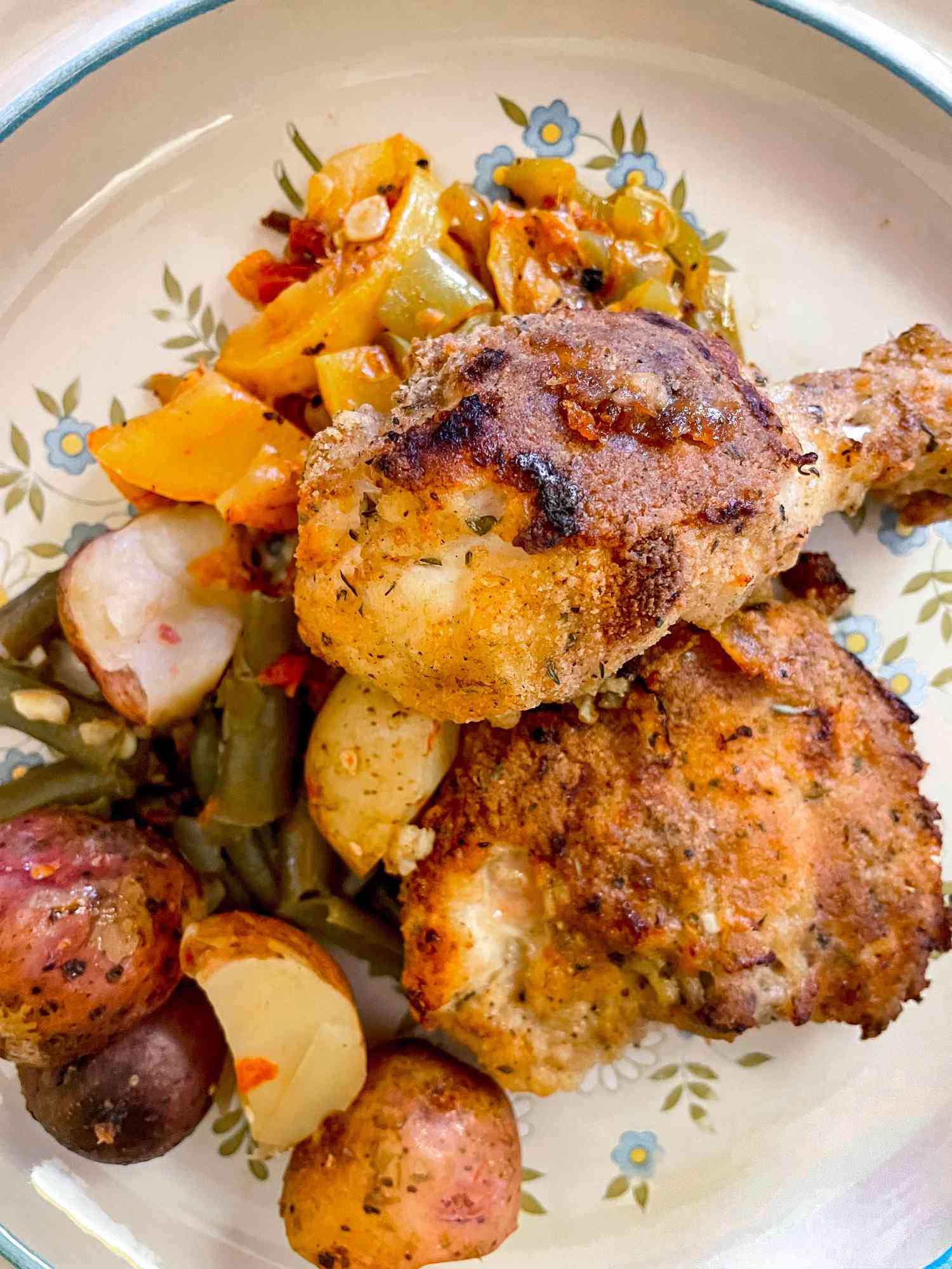 Plate of un-fried chicken served with vegetables (green beans, potatoes, and a squash stir-fry)