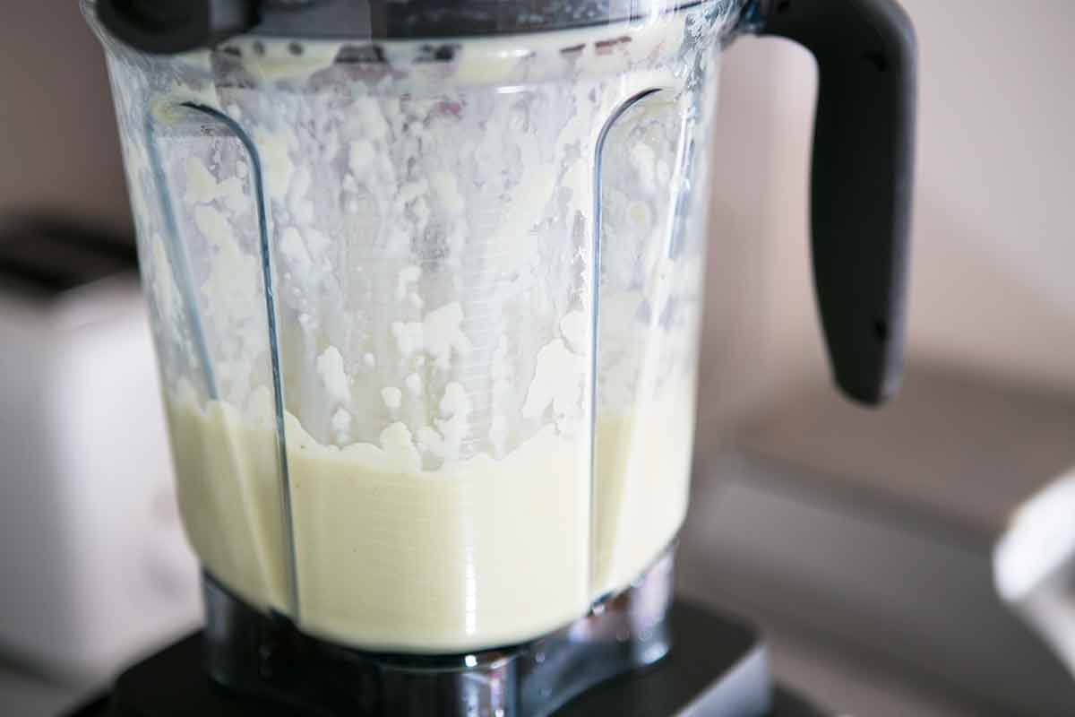 Puréeing creamy celery soup in a blender