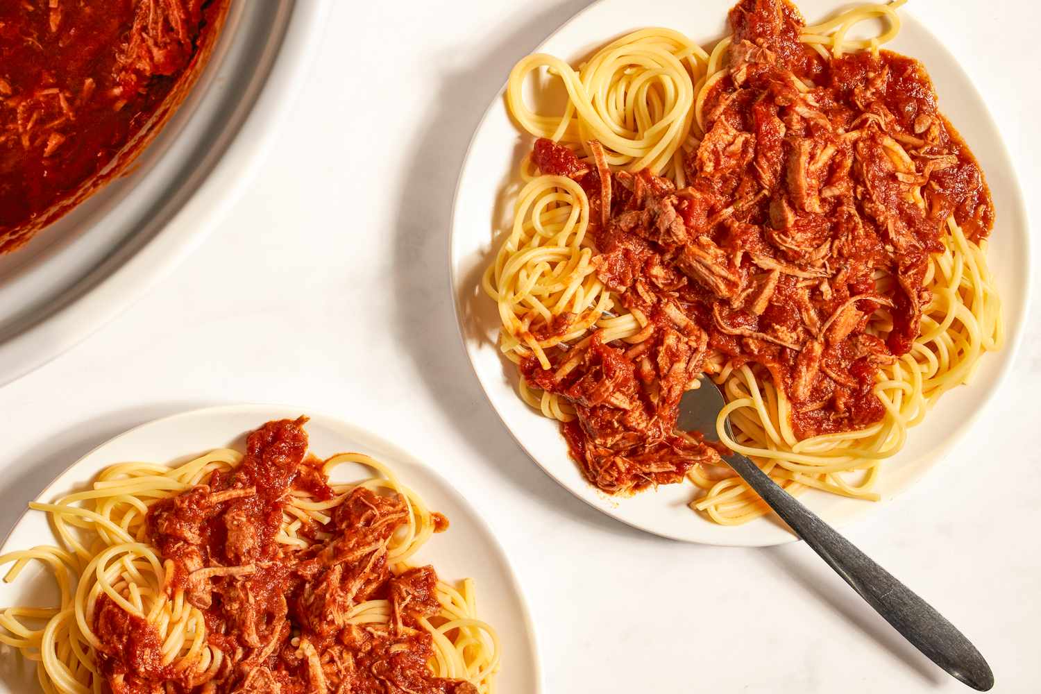 Plates of spaghetti with a tomatobased meat sauce presented for a meal