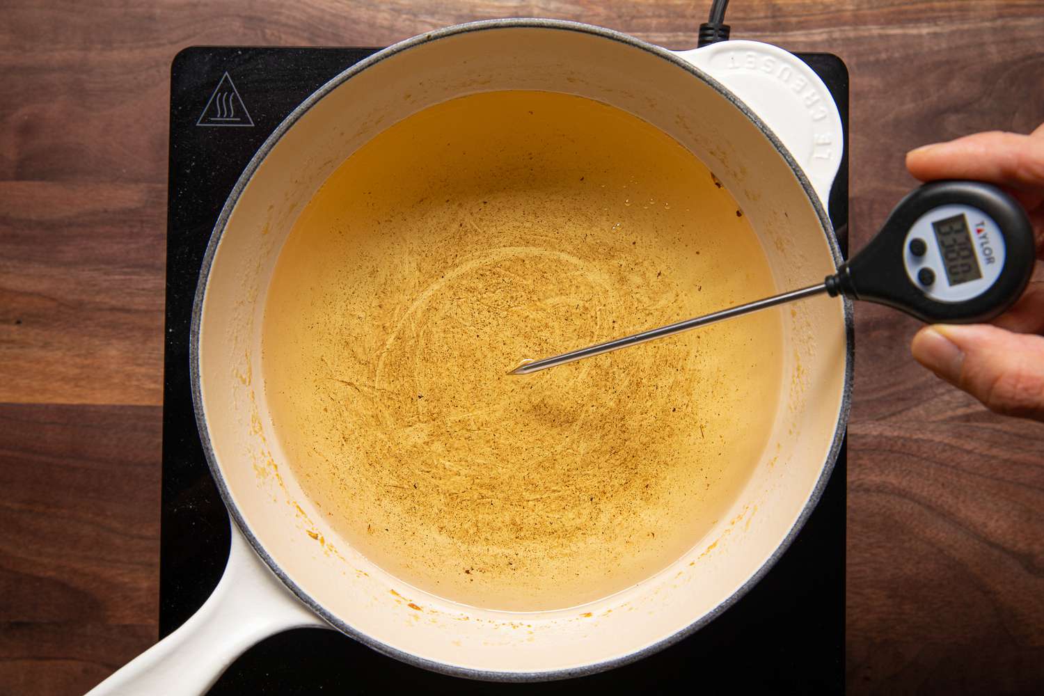 Pot of Oil Heating on a Portable Stove With a Thermometer Reading 338 F